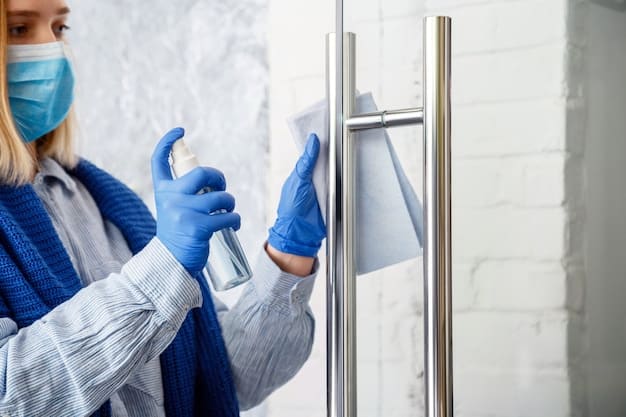 A close-up of a staff member properly disinfecting a kennel with appropriate cleaning supplies, wearing protective gear.