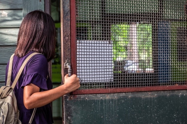 A detailed shot of a ticket booth at a wildlife park entrance, showing people purchasing tickets. Signage indicates entrance fees and other costs associated with visiting the park, highlighting the direct revenue generated.