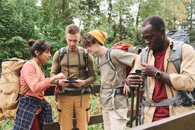 A group of tourists listening attentively to a local guide during a wildlife tour. The guide is pointing out different species of birds, demonstrating his expertise and contribution to the tourism experience.