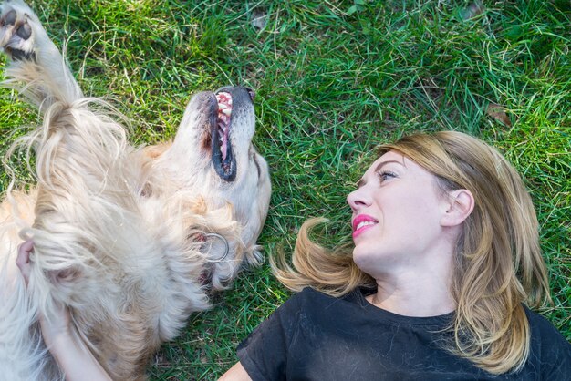 A close-up of a dog barking intensely at a person walking by outside, showing the dog's teeth and intense focus.