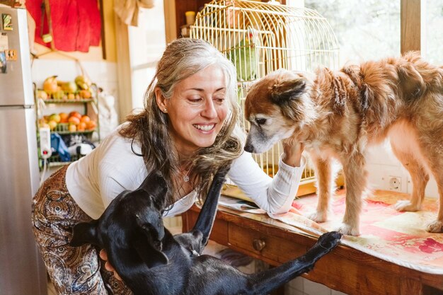 A volunteer happily playing with a group of playful puppies at the animal shelter. The volunteer is smiling and gently interacting with the puppies, with a clean and inviting play area in the background.